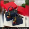 شنطة GUESS كحلي بتعليقة الكرز