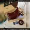 شنطة Coach Tabby مع ميدالية (أسود أبيض وردي جملي عنابي)